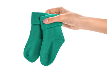 Woman holding baby socks on white background