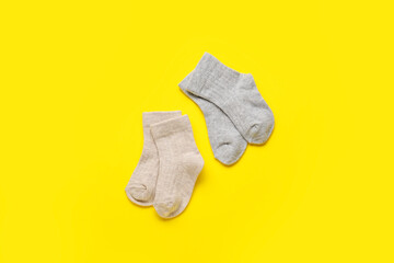 Baby socks on color background