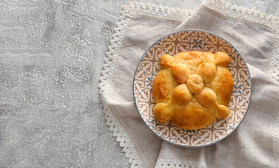 Plate with bread of the dead on grunge background. Celebration of Mexico's Day of the Dead (El Dia de Muertos)