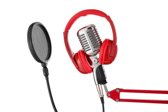 Modern microphone with pop filter and headphones on white background