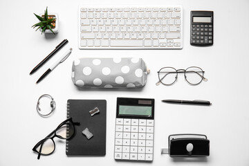 Pencil case, keyboard, female accessories and stationery on white background