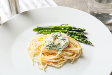 Plate of tasty pasta with vegetables, closeup