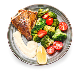Plate with tasty baked cod fillet and vegetables on white background