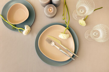 Stylish table setting and ranunculus flowers