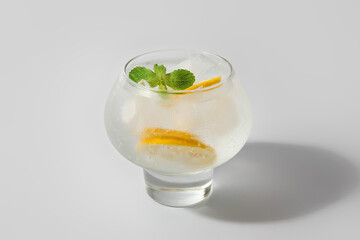 Glass of cold gin and tonic on white background