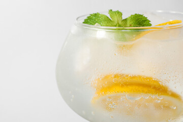 Glass of cold gin and tonic on white background