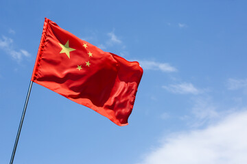 Naklejka na ściany i meble Flag of China against blue sky