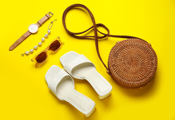 Female shoes and stylish accessories on color background