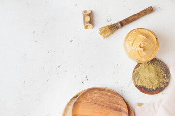 Composition with tasty dalgona hojicha latte on light background