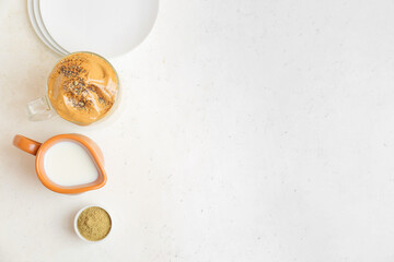 Composition with tasty dalgona hojicha latte on light background