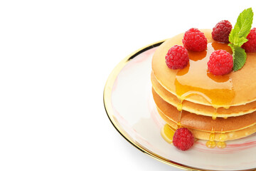 Plate of tasty pancakes with honey and berries on white background, closeup