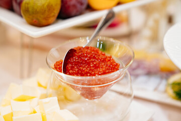 a bowl of red caviar and butter on the dining table. delicacies for the holiday