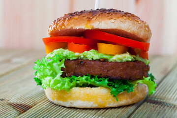 Image of vegetarian hamburger with soybean cutlet, tomato and lettuce