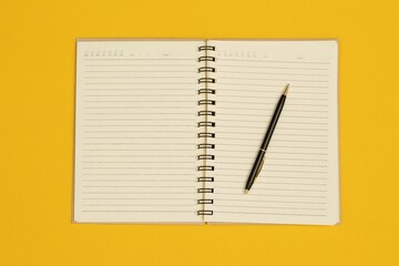 Notebooks and pens are used in the design of various publications.
