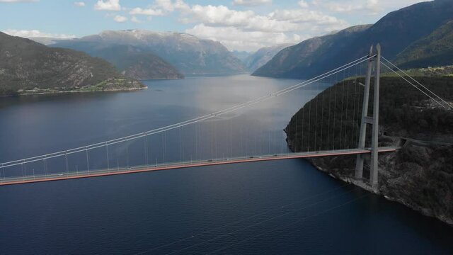 Aerial: amazing Hardanger Bridge, long suspension bridge in Eidfjorden Norway 4K