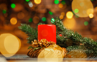Christmas home room with tree and festive bokeh lighting, blurred holiday background. Burning candle. Beautiful Xmas decoration. Candle inside over festive blurry bokeh background. Happy New Year time