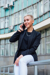 Young stylish business woman with short hair and nose piercing