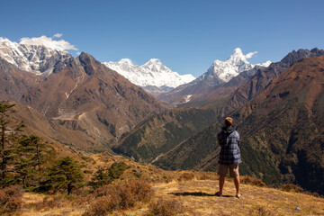 Fototapeta na wymiar Trekker takes in spectacular view of famous Everest mountain range.