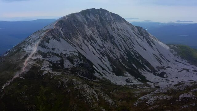 Mount Errigal, Derryveagh Mountains, Gortahork, County Donegal, Ireland, September 2021. Drone gradually orbits the north-western face with Dunlewy and Nacung Loughs in the distance.