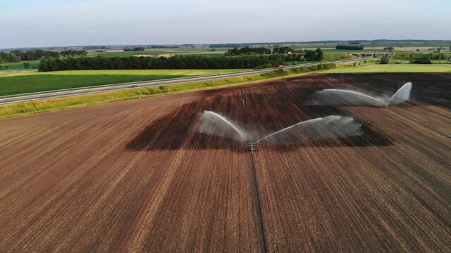 Flying a drone towards water sprinklers next to a highway