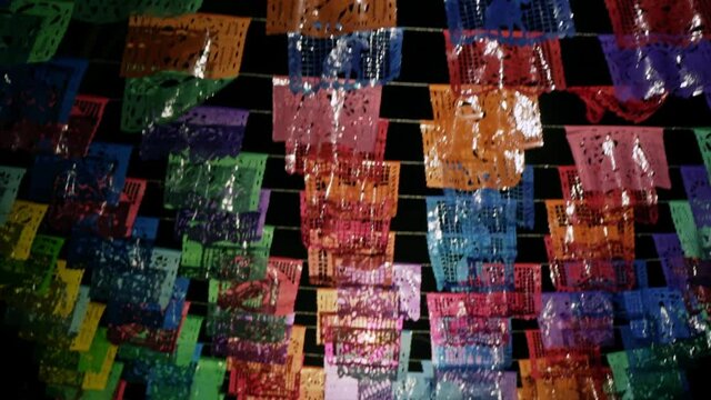 Line of Papel Picado perforated paper in Mexican town at night time