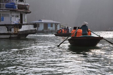Boat and water house in Ha Long Bay, Vietnam.