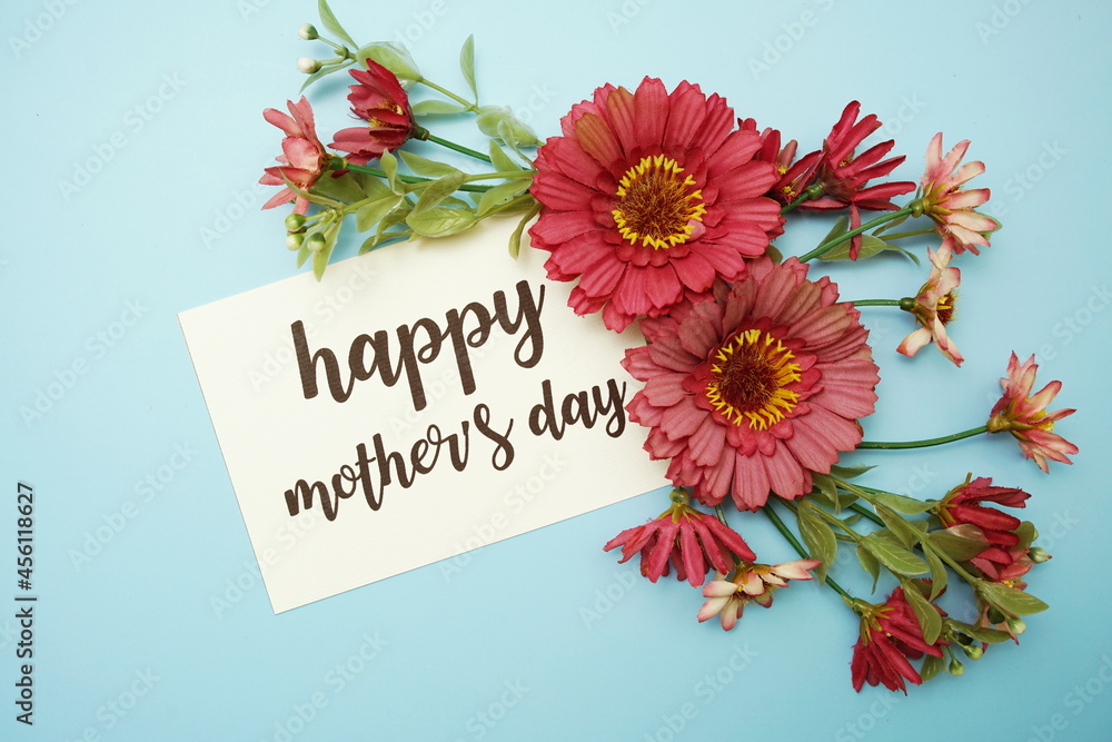 Wall mural Happy Mother's day typography text with daisy flowers on blue background