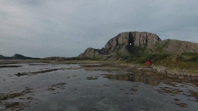 Torghatten Granite Dome Known For Its Natural Hole Through Its Center, Situated In The Island Of Torget In Bronnoysund, Norway. low drone shot