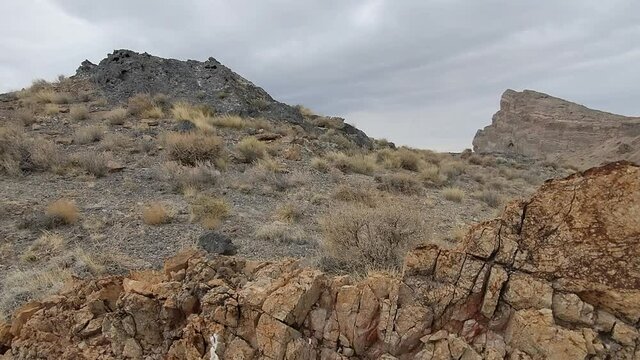 Silent prairie landscape of barren mount, stone and cliff