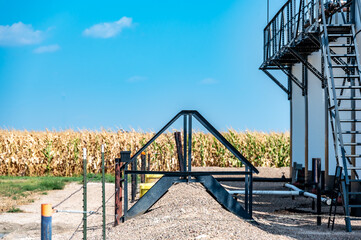 Ramp and stairs over a secondary containment dike for chemical oil storage confined space
