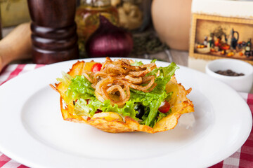 salad with greens, olives, fried onions and cherry tomatoes
