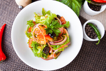 salad with greens tomatoes olives onions in a sweet sauce
