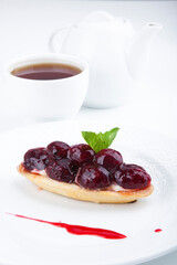 delicious sweet dessert on white plate with tea
