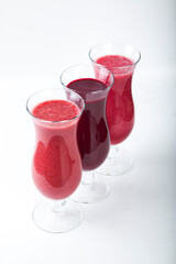 bright berry smoothies on a white background