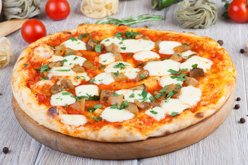 pizza on a wooden light background with decorative design
