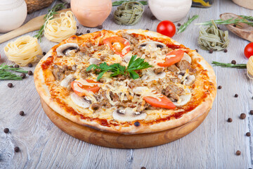pizza on a wooden light background with decorative design
