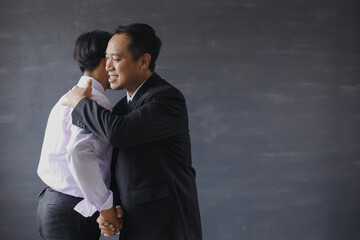 The boss hugs his employees to congratulate him