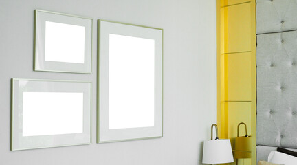 three different size of blank picture frames mockup on white wall background in the bedroom