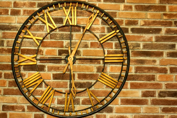 Big vintage clock on a brick wall