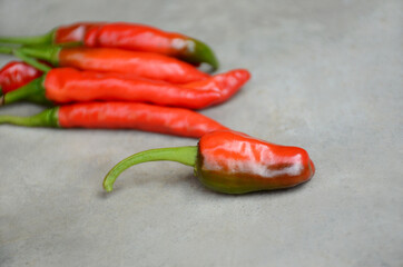 closeup the bunch red ripe chilly over out of focus grey background.