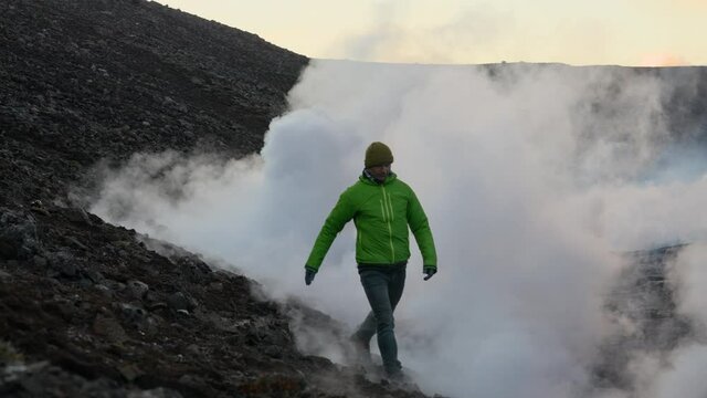 Man Walking Through Smoke Of Lava Flow From Erupting Fagradalsfjall Volcano