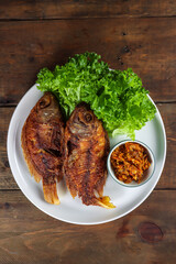 Ikan nila goreng sambal bawang. Popular Indonesian seafood dish of fried fish with garlic sauce.