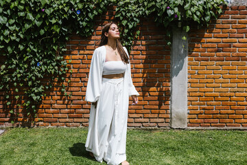 latin holistic therapist woman breathing calmly standing in the garden in Latin America
