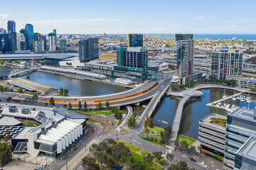 Aerial view of urbanized city with trees, bridges, roads, river and tall buildings