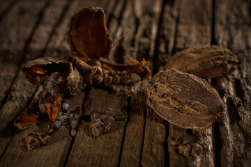 Black cardamon against wooden background