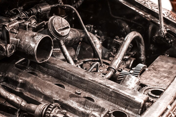 The car made of metal parts, screws, bolts, gears, nails. Engine, motor with pipes and wires....