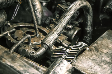 The car made of metal parts, screws, bolts, gears, nails. Engine, motor with pipes and wires. Futuristic ancient vintage automobile with mechanisms in the steampunk style.