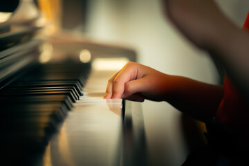 girl learns to play the piano