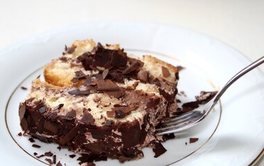 Eating chocolate cake with cream and chocolate chips