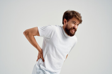 man in a white t-shirt stress medicine backache isolated background